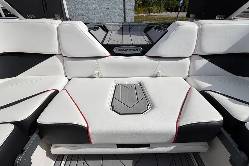 Slide: The Image of 2019 Supra SL 450 boat interior with white seating and red accents. - 10