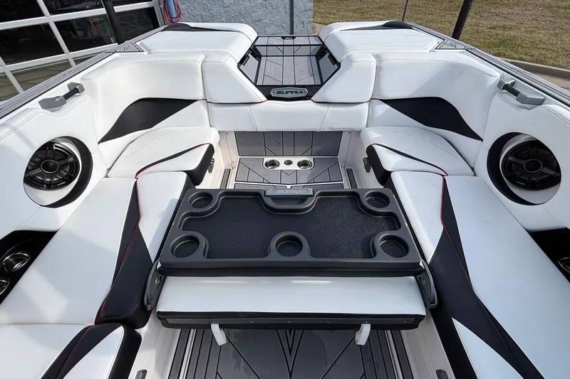 Slide: The Image of 2019 Supra SL 450 boat interior with white seating and cup holders. - 15