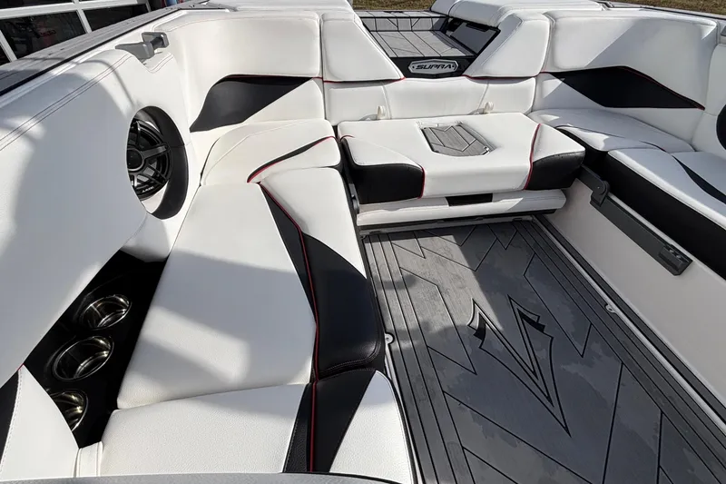 Slide: The Image of 2019 Supra SL 450 boat interior with white and black seating, stylish design. - 22