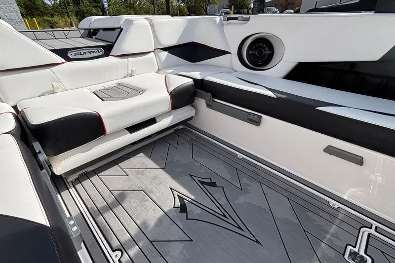 Slide: The Image of 2019 Supra SL 450 boat interior with white seating and speaker system. - 23