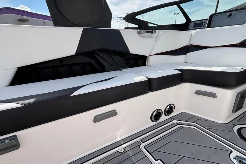 Slide: The Image of 2019 Supra SL 450 boat interior with sleek white and black seating design. - 25