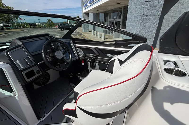 Slide: The Image of 2019 Supra SL 450 boat interior with modern dashboard and white seating. - 26