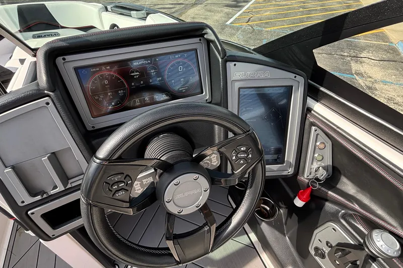 Slide: The Image of 2019 Supra SL 450 boat dashboard with advanced digital controls and steering wheel. - 28