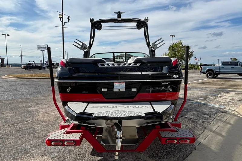 Slide: The Image of 2019 Supra SL 450 boat, rear view, parked outdoors on a sunny day. - 3