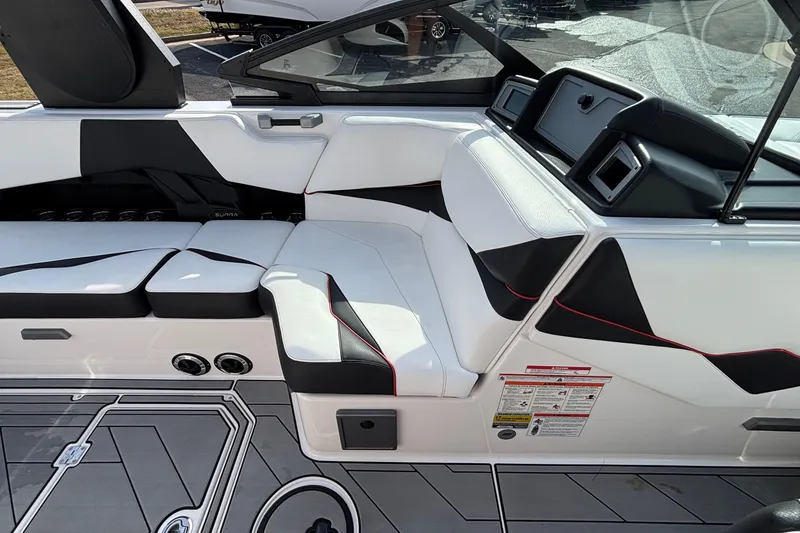Slide: The Image of 2019 Supra SL 450 boat interior with sleek white and black seating design. - 32