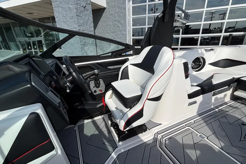 Slide: The Image of 2019 Supra SL 450 boat interior with sleek black and white seating and modern dashboard. - 35