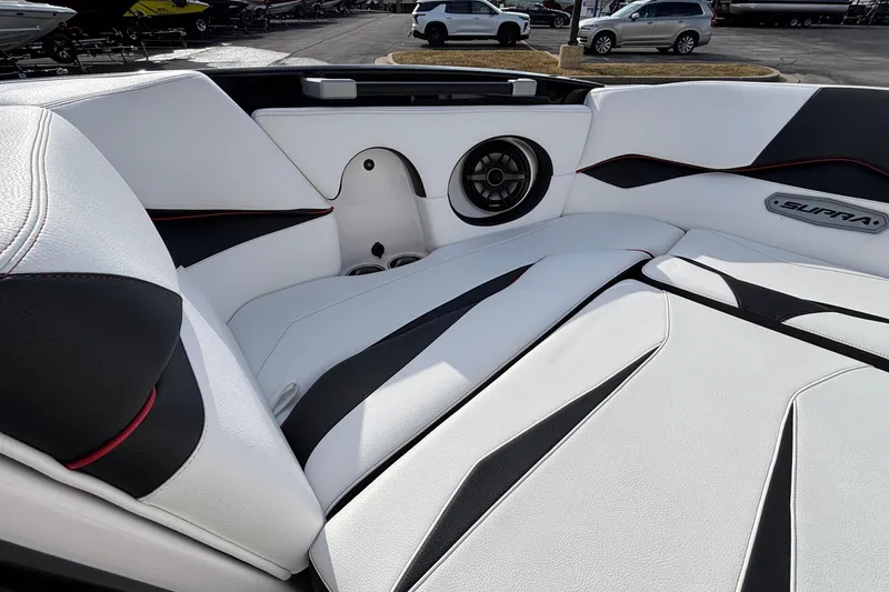 Slide: The Image of 2019 Supra SL 450 boat interior with sleek white and black seating design. - 37