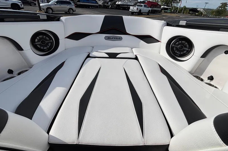 Slide: The Image of 2019 Supra SL 450 boat interior with sleek white and black seating design. - 38