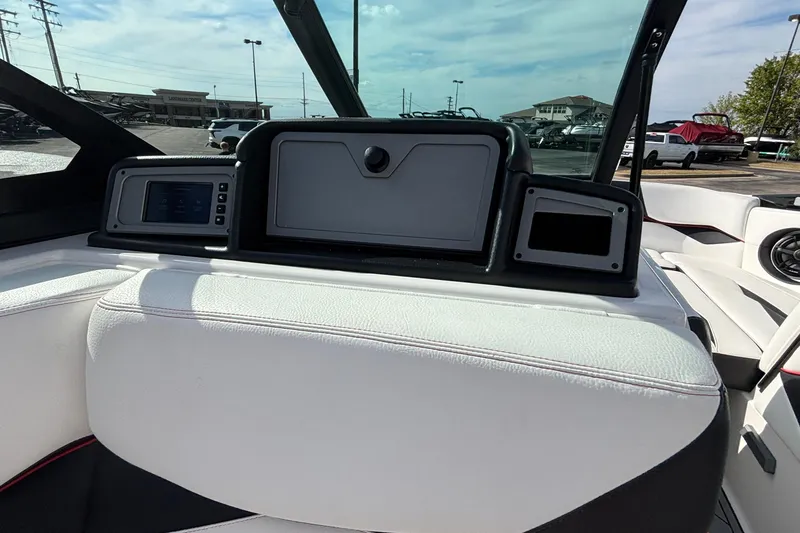 Slide: The Image of 2019 Supra SL 450 boat interior dashboard with white seating and digital displays. - 43