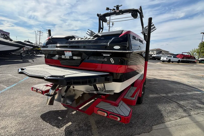 Slide: The Image of 2019 Supra SL 450 boat with red and black design, parked on a trailer. - 49