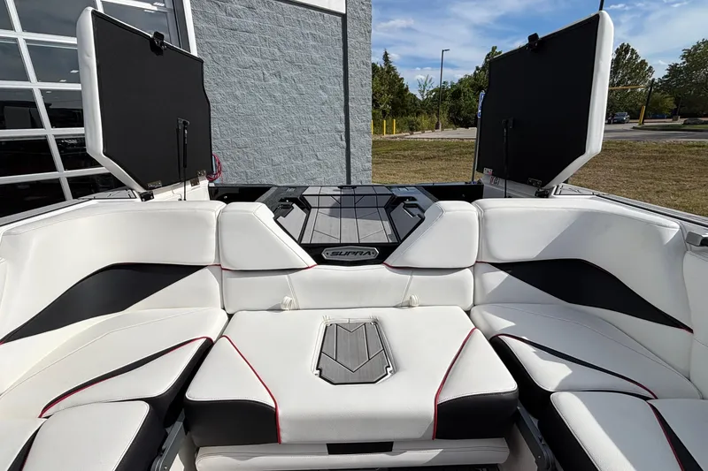 Slide: The Image of 2019 Supra SL 450 boat interior with white seating and open storage compartments. - 9