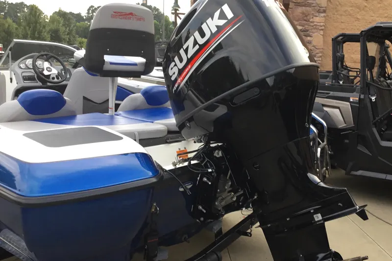 Slide: The Image of 2011 Skeeter SL190 boat with Suzuki outboard motor, blue and white seating. - 11