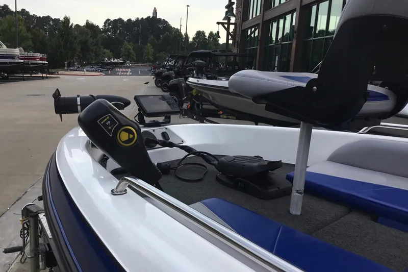 Slide: The Image of 2011 Skeeter SL190 boat with trolling motor and seating, parked outdoors. - 3