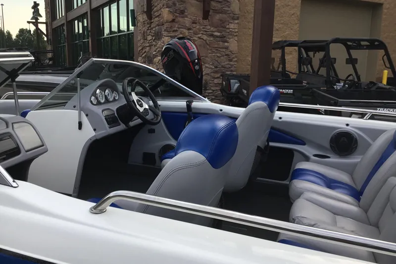 Slide: The Image of 2011 Skeeter SL190 boat interior with blue and gray seating, dashboard, and steering wheel. - 8