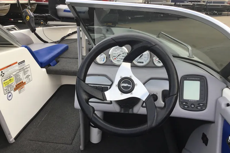 Slide: The Image of 2011 Skeeter SL190 boat dashboard with steering wheel and gauges. - 9