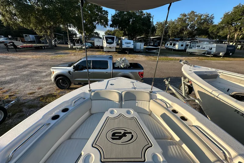 Slide: The Image of 2022 Sea Fox 228 Commander boat interior with truck and trailers in the background. - 53