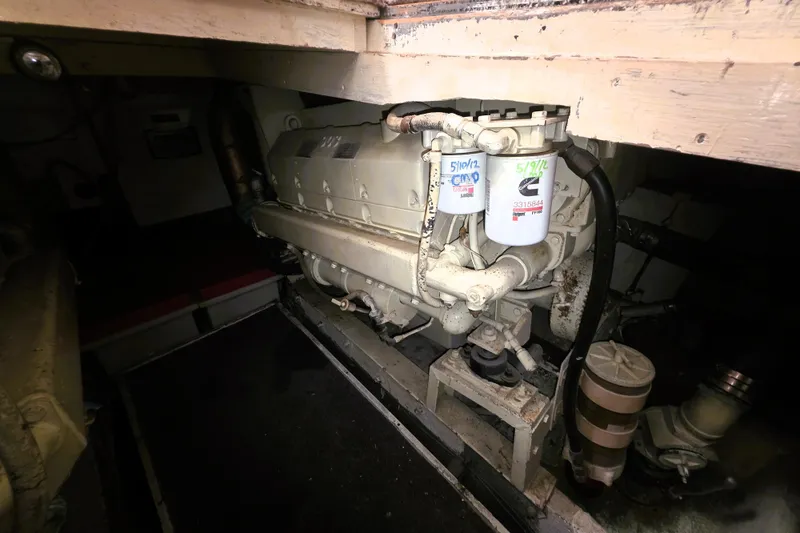 Slide: The Image of Engine room of a 1979 Trojan 44 Motor Yacht, featuring mechanical components. - 27