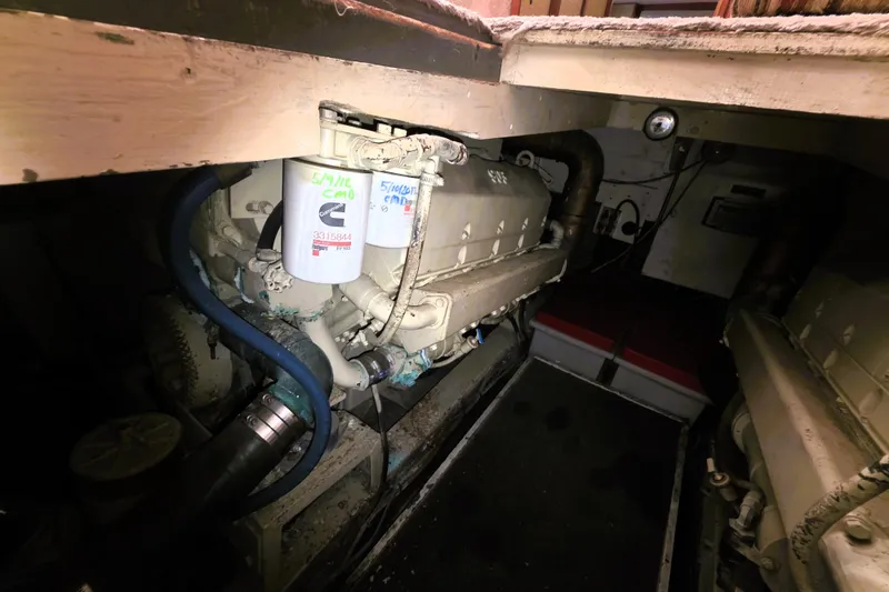 Slide: The Image of Engine room of a 1979 Trojan 44 Motor Yacht, showcasing mechanical components and filters. - 28