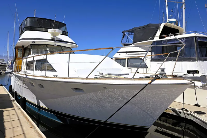 Slide: The Image of 1979 Trojan 44 Motor Yacht docked at marina under clear blue sky. - 38