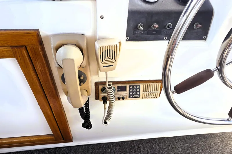 Slide: The Image of 1979 Trojan 44 Motor Yacht helm with vintage communication equipment and steering wheel. - 42