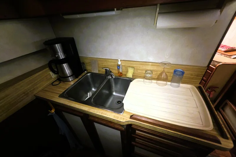 Slide: The Image of 1979 Trojan 44 Motor Yacht kitchen with sink, coffee maker, and countertop accessories. - 8