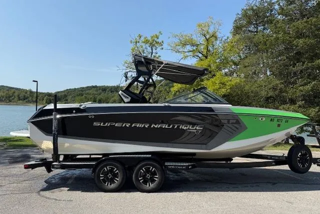 The Image of 2017 Nautique Super Air Nautique G23 boat on trailer by a lake. - 1