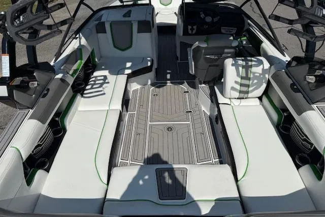 Slide: The Image of 2017 Nautique Super Air Nautique G23 interior with white seating and green accents. - 14