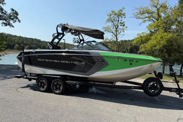 Slide: The Image of 2017 Nautique Super Air Nautique G23 boat on trailer by a lake. - 3