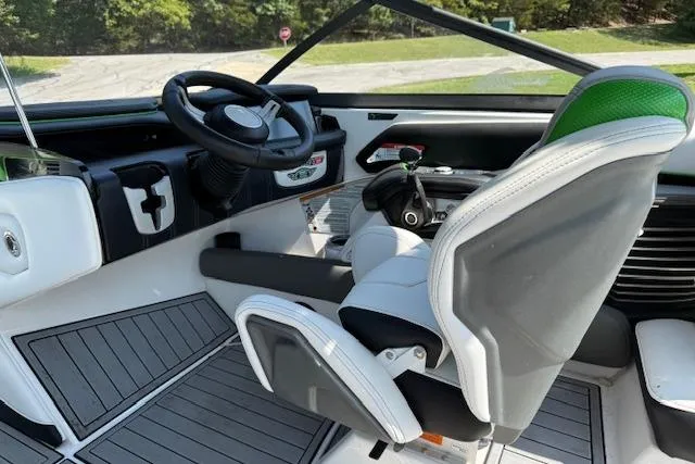 Slide: The Image of Interior of 2017 Nautique Super Air Nautique G23 boat, featuring sleek steering and seating. - 8