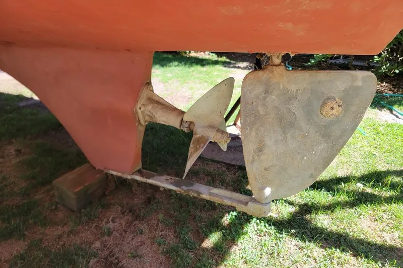 Slide: The Image of Propeller and rudder of 1997 Albin 28 Tournament Express boat on grass. - 13