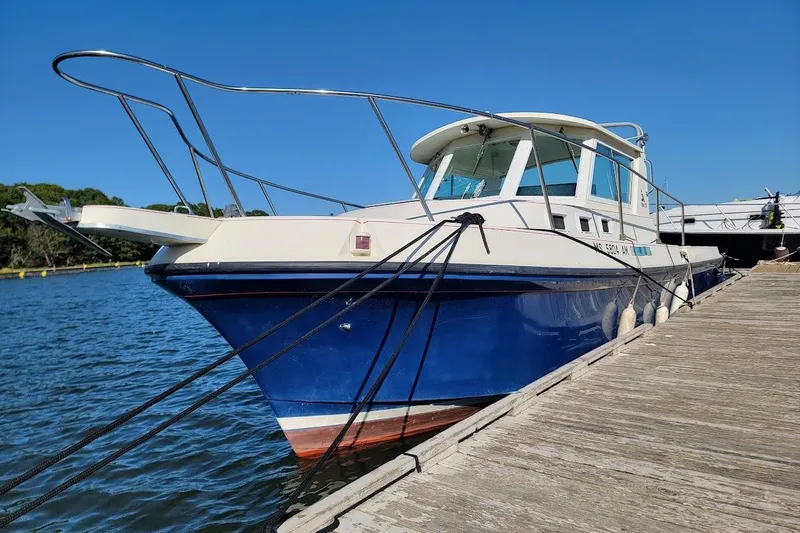 Slide: The Image of 1997 Albin 28 Tournament Express boat docked on a sunny day. - 16