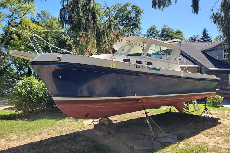 Slide: The Image of 1997 Albin 28 Tournament Express boat on stands in a residential yard. - 17