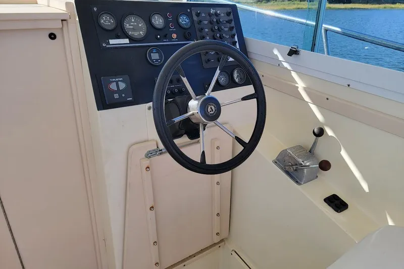 Slide: The Image of Steering console of a 1997 Albin 28 Tournament Express boat with gauges and controls. - 2