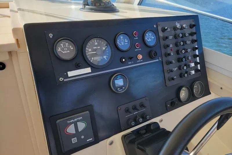 Slide: The Image of Control panel of a 1997 Albin 28 Tournament Express boat with gauges and switches. - 3