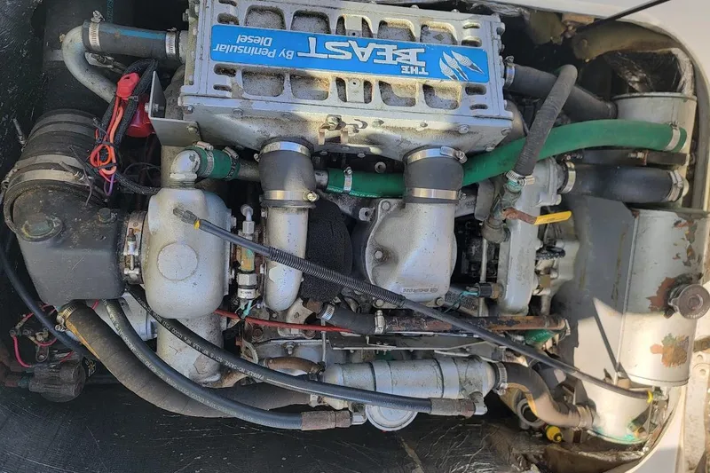 Slide: The Image of Engine of a 1997 Albin 28 Tournament Express boat, featuring a Peninsular diesel system. - 4
