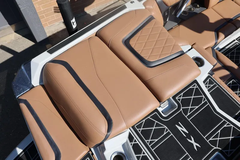 Slide: The Image of 2021 Tigé 21ZX boat interior with tan leather seats and stylish design. - 11