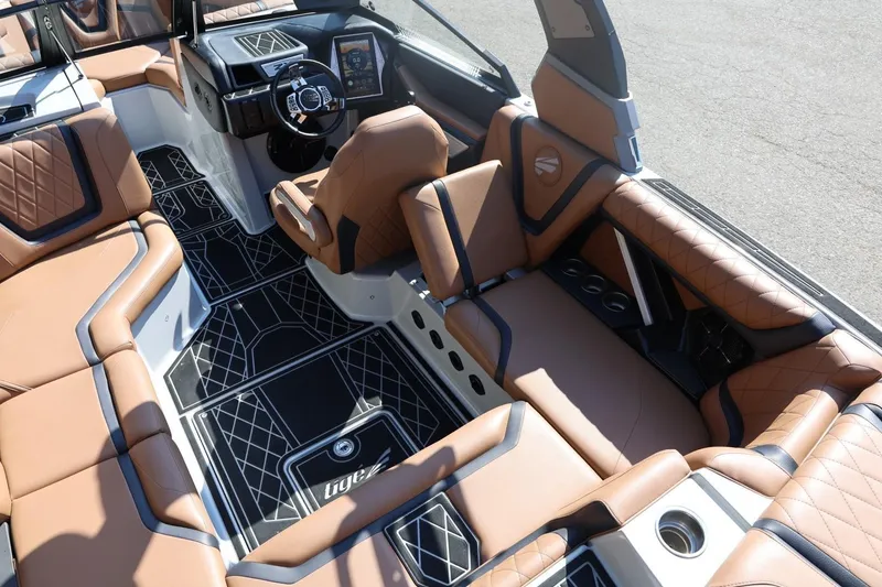 Slide: The Image of Luxurious interior of 2021 Tigé 21ZX boat with tan leather seating and modern dashboard. - 13