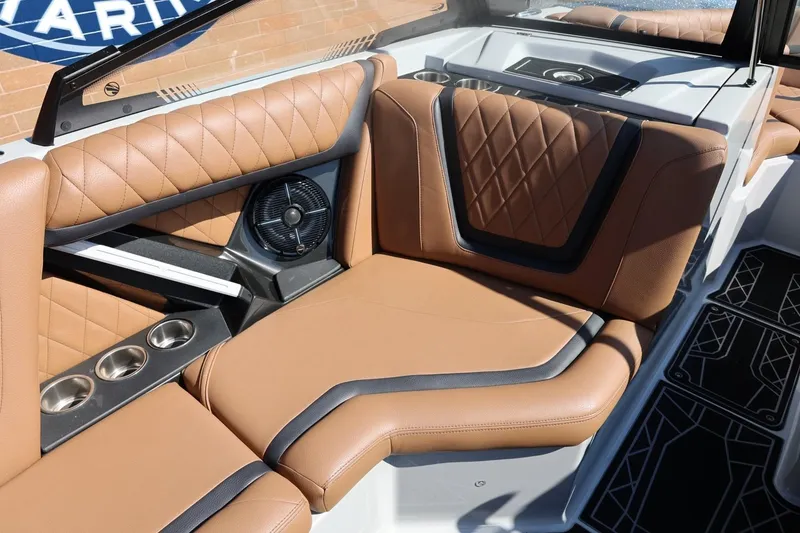 Slide: The Image of 2021 Tigé 21ZX boat interior with tan leather seating and cup holders. - 14