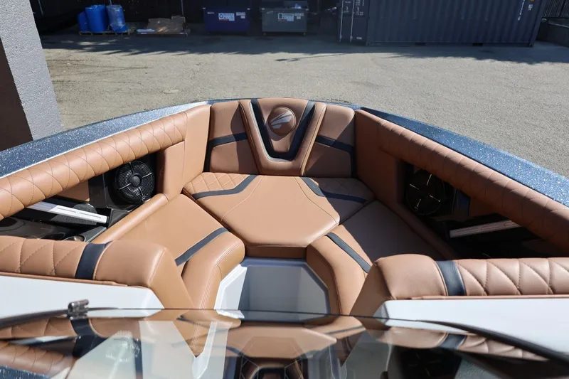 Slide: The Image of 2021 Tigé 21ZX boat interior with tan leather seating and speakers. - 16