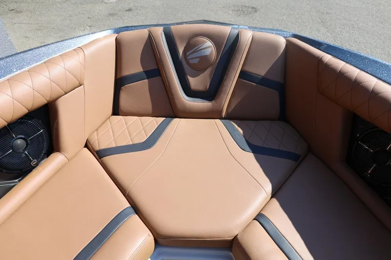 Slide: The Image of 2021 Tigé 21ZX boat interior with tan and black cushioned seating. - 20