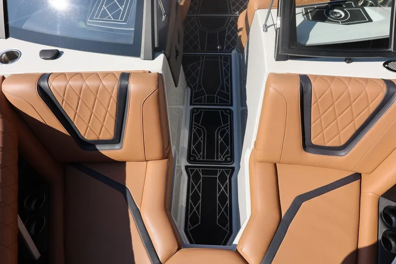 Slide: The Image of 2021 Tigé 21ZX boat interior with tan leather seats and modern design. - 21