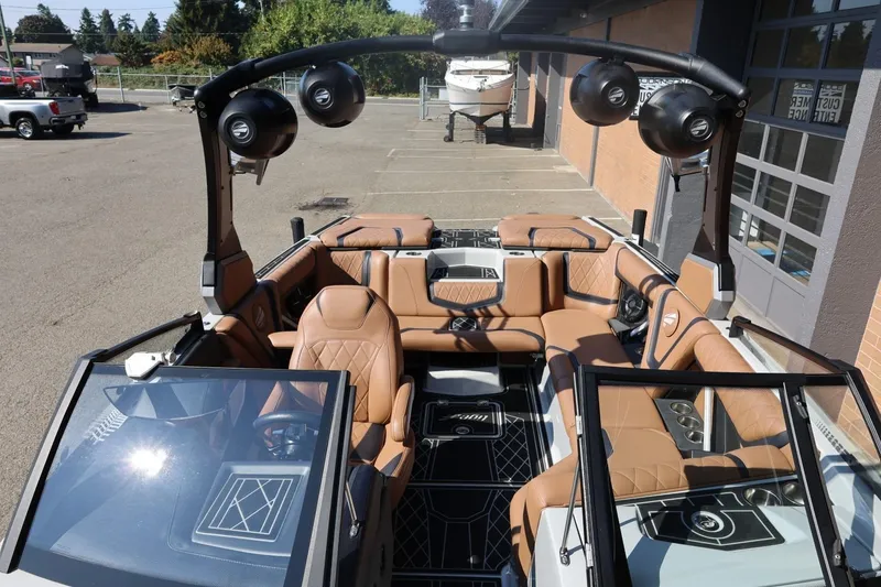 Slide: The Image of 2021 Tigé 21ZX boat interior with luxurious tan seating and advanced audio system. - 22