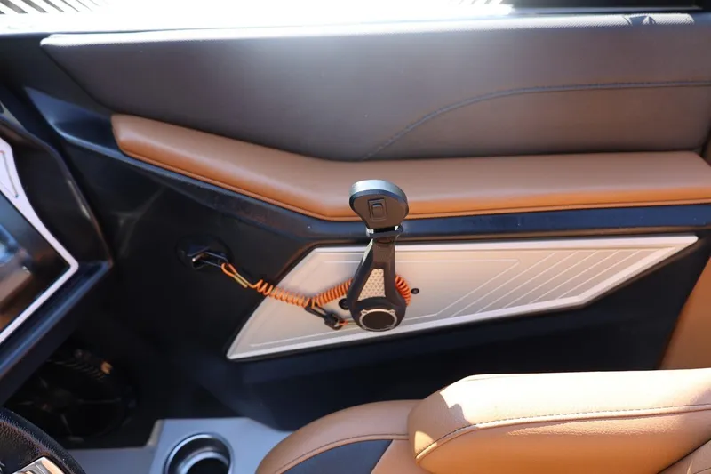 Slide: The Image of 2021 Tigé 21ZX interior detail with brown leather and modern design elements. - 25