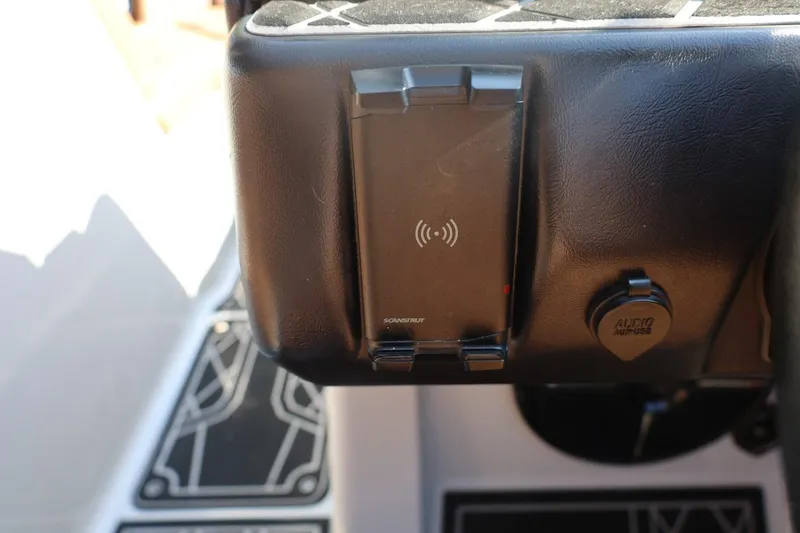 Slide: The Image of 2021 Tigé 21ZX dashboard with wireless charging pad and audio input. - 27