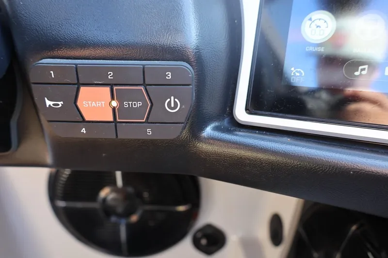 Slide: The Image of Dashboard controls of a 2021 Tigé 21ZX boat with start-stop buttons. - 28