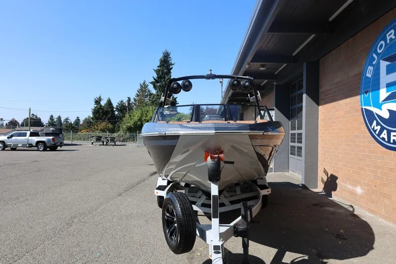 Slide: The Image of 2021 Tigé 21ZX boat on trailer outside a marine dealership. - 3