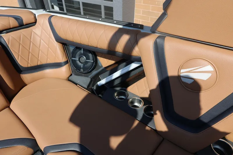 Slide: The Image of 2021 Tigé 21ZX boat interior with tan leather seats, cup holders, and speaker. - 41