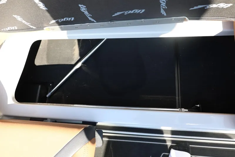 Slide: The Image of 2021 Tigé 21ZX boat storage compartment with open lid and visible interior. - 44