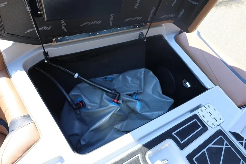 Slide: The Image of 2021 Tigé 21ZX boat storage compartment with ballast bag and hoses. - 47
