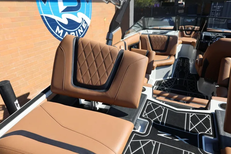 Slide: The Image of 2021 Tigé 21ZX boat interior with luxurious brown leather seating and modern design. - 49